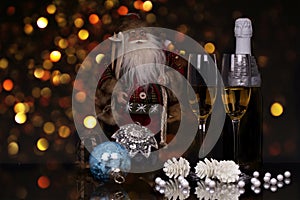 Glasses champagne, bottle, Santa Claus and Christmas decoration