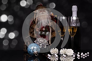 Glasses champagne, bottle, Santa Claus and Christmas decoration