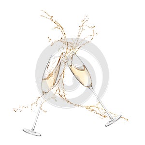 Glasses of champagne clinking together and splashing on white