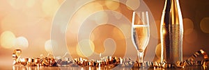 Glasses of champagne on a festive gold bokeh background. New Year or Christmas sparkling horizontal background with copy