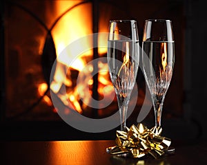 Glasses with champagne, fire as the background