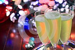 Glasses of champagne in front of colorful bokeh lights