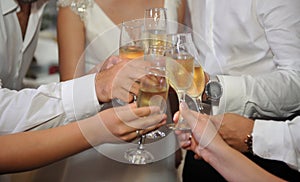 Glasses of champagne in the hands of guests at a wedding
