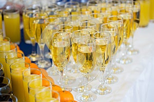 Glasses with champagne on the party table. lot of