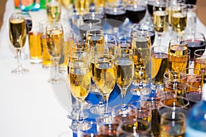 Glasses with champagne on the party table. lot of