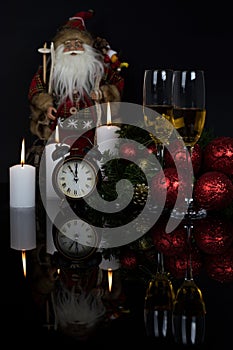 Glasses with champagne, Santa Claus and christmas decoration
