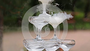 Glasses Of Champagne Smoking. Champagne glasses. Smoke Billowing Over A Champagne Flute. Catering service. Wedding slide photo