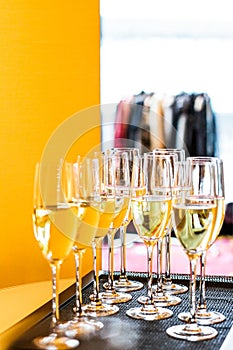 Glasses of champagne and sparkling wine served on a tray during charity event