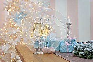 Glasses of champagne surrounded by luxury Christmas New year background and decoration, light bokeh effect