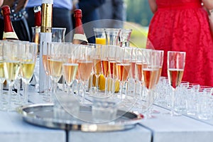 Glasses with champagne and wine on summer wedding