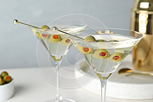 Glasses of Classic Dry Martini with olives on table