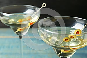 Glasses of Classic Dry Martini with olives on table, closeup