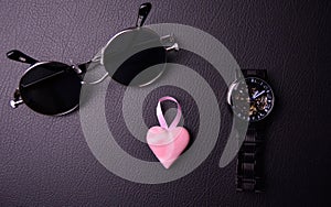 glasses and clock in the style of steampunk with a pink heart in the center on a black background