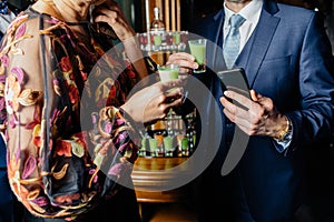 Glasses of cocktails on bar background photo