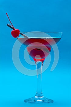 Glasses of cocktails on blue background