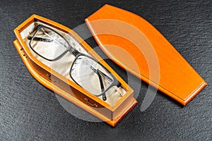 Glasses in coffin.Laser eye surgery or Buy Your Contact Lenses concept