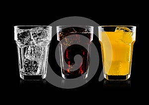 Glasses of cola and orange soda drink and lemonade photo