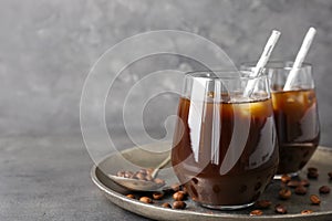 Glasses with cold brew coffee and beans