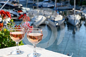 Glasses of cold white Cote de Provence wine in yacht harbour of Port Grimaud, summer vacation on French Riviera in Provence,