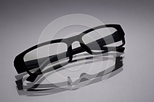glasses for a computer in a black frame closeup on a gray surface