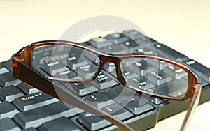 Glasses on the computer keyboard