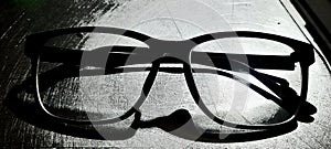 Glasses in dark shadow black night