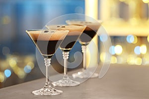 Glasses of delicious Espresso Martini on bar counter