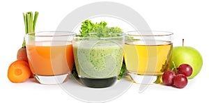 Glasses of delicious juices, fresh fruits and vegetables on white background