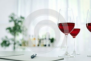 Glasses with delicious wine on table