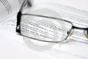 Glasses on dictionary