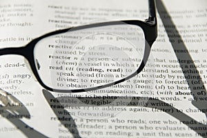 Glasses on dictionary, detail