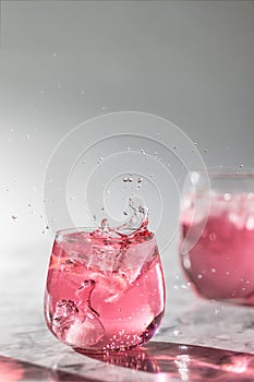 The glasses of drink with ice and splashes