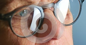 Glasses, eye vision and face of senior person trying out a new pair of spectacles, specs or eyeglasses. Zoom macro, eyes