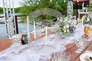 Glasses on the festive table setting. Wedding table decor concept. Table setting in classic style, setout. fine art.