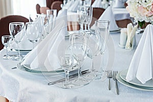 Table with glasses and napkins served for dinner in restaurant