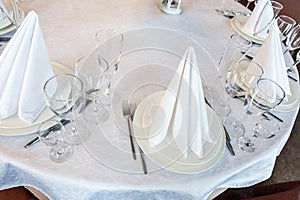 Table with glasses and napkins served for dinner in restaurant