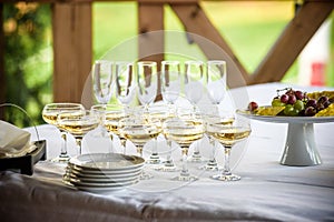 Glasses, forks, knives, napkins and decorative flower on a table served for dinner in cozy restaurant.