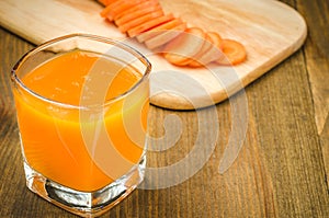 Glasses fresh carrot juice ready for you/glasses fresh carrot juice ready for you on a wooden background. selective focus. copy