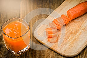 glasses fresh carrot juice ready for you/glasses fresh carrot juice ready for you on a wooden background. Toned. Top view
