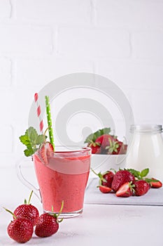 Glasses of fresh cold smoothie with fruit and berries, on white table background. Healthy food for breakfast, snack