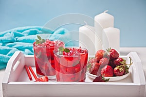 Glasses with fresh homemade strawberry sweet iced tea or cocktail, lemonade with mint. Refreshing cold drink and plate with