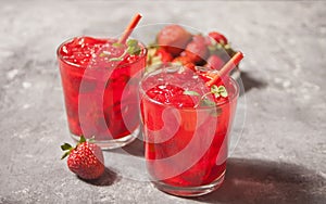 Glasses with fresh homemade strawberry sweet iced tea or cocktail, lemonade with mint. Refreshing cold drink. Summer