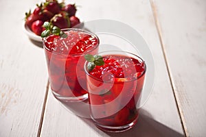 Glasses with fresh homemade strawberry sweet iced tea or cocktail, lemonade with mint. Refreshing cold drink. Summer party