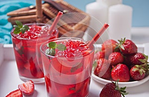 Glasses with fresh homemade strawberry sweet iced tea or cocktail, lemonade with mint. Refreshing cold drink. Summer pool party.