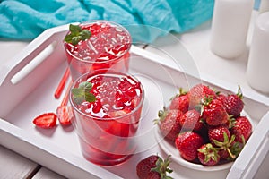 Glasses with fresh homemade strawberry sweet iced tea or cocktail, lemonade with mint. Refreshing cold drink. Summer