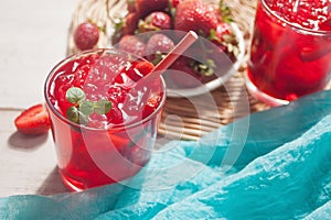 Glasses with fresh homemade strawberry sweet iced tea or cocktail, lemonade with mint. Refreshing cold drink. Summer