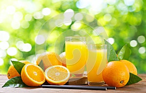 glasses of fresh orange juice with fresh fruits