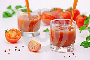 Glasses of fresh tomato juice with tomatoes