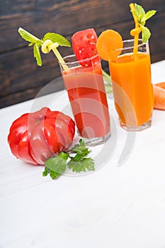 Glasses of freshly made tomato and orange juice