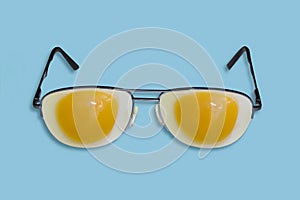 Glasses with fried eggs on a blue background.